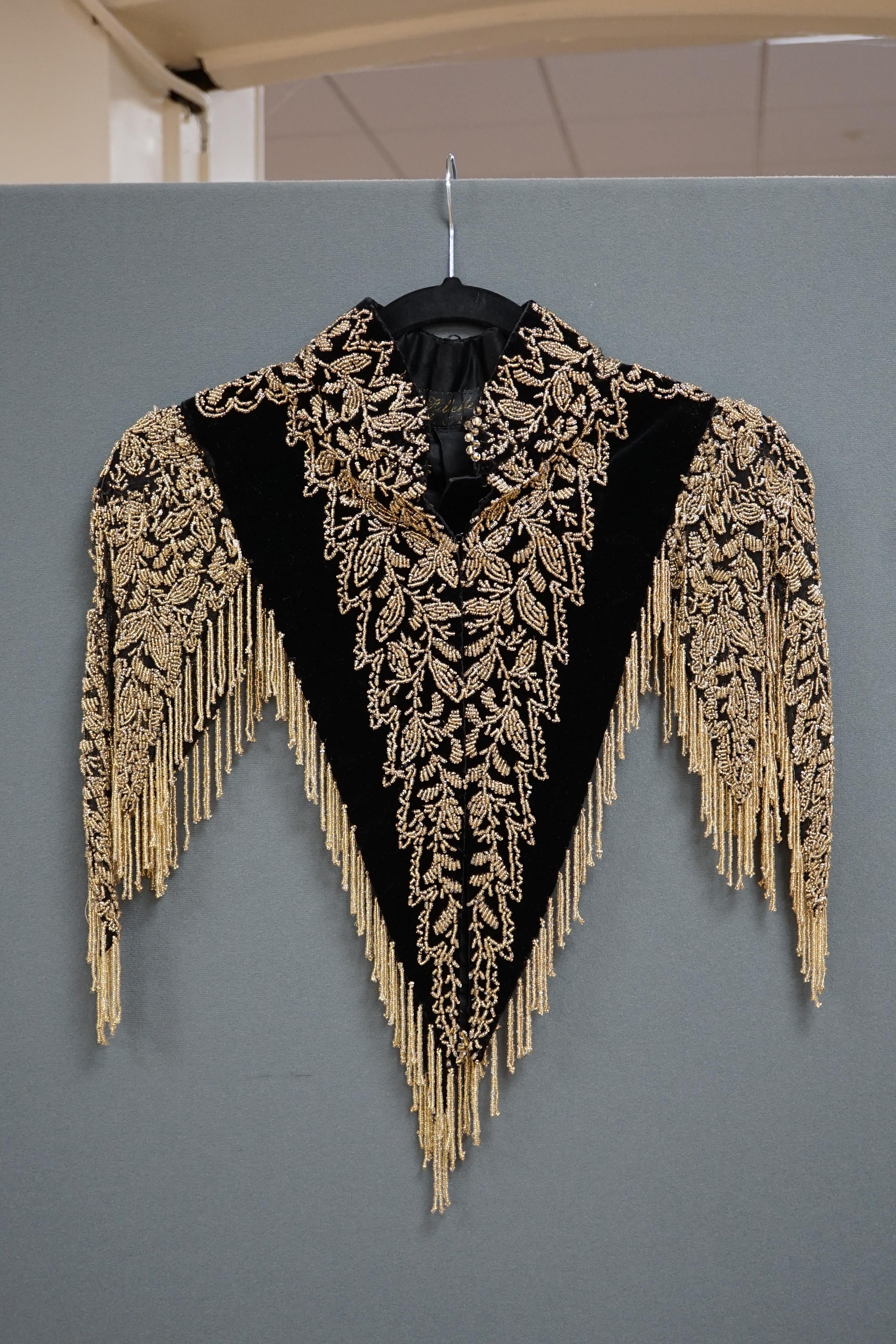 An Edwardian French black velvet and elaborately beaded evening over collar, with makers label, ‘Fillet’, designed with a high collar, front and back panels, all heavily bead worked in an intricate floral design, attache